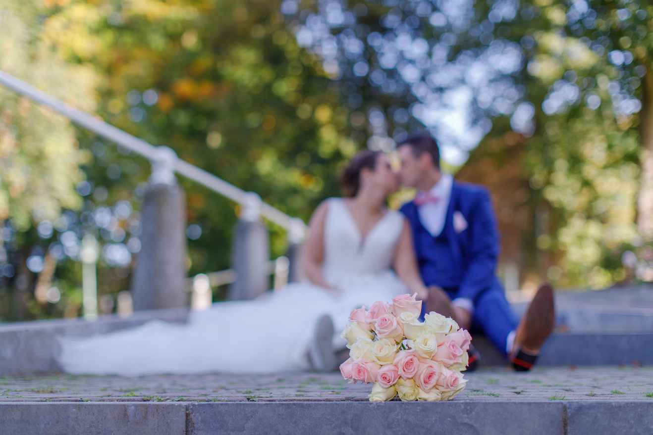 Newly-wed Couple Sitting And Kissing